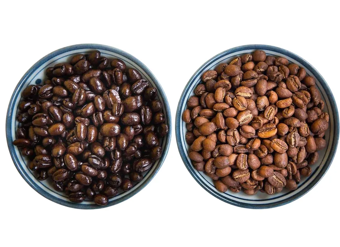 Sorted peaberry beans — small, rounded, single-seeded — separated from the standard flat beans of the same lot.